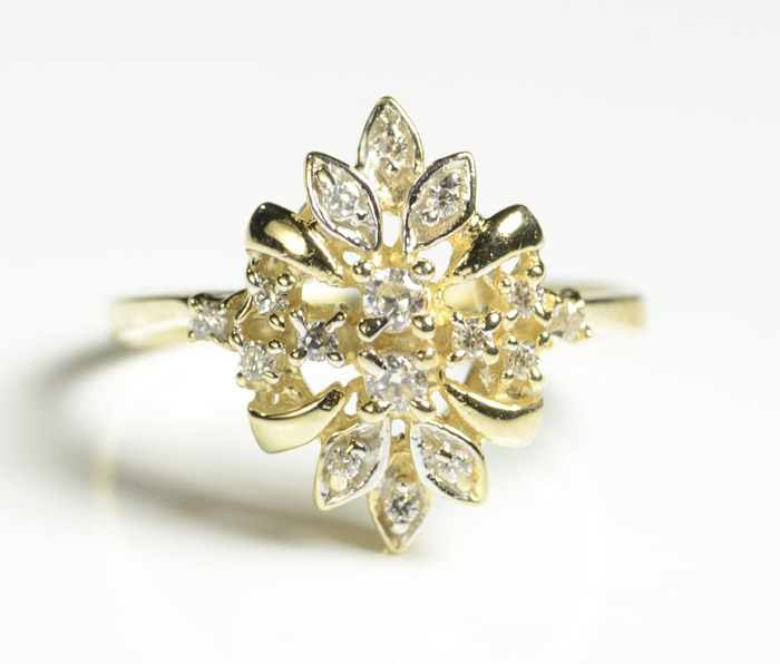 Appraisal: FAUX DIAMOND AND FOURTEEN KARAT GOLD RING set with round-cut