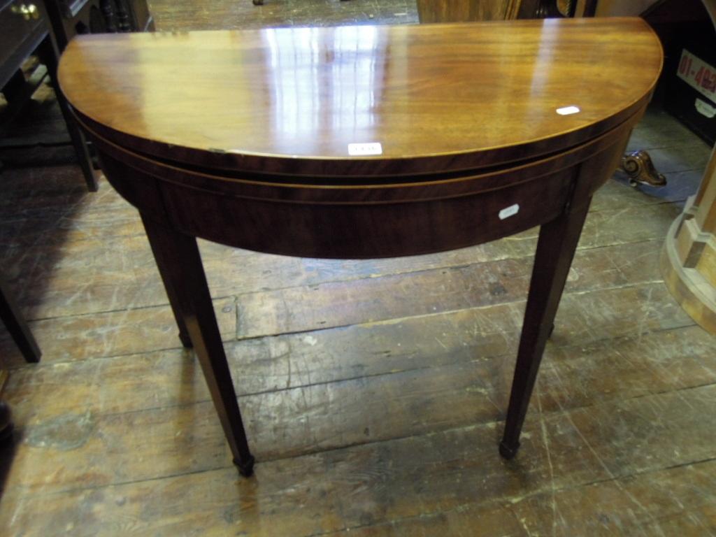 Appraisal: A Georgian mahogany demi-lune fold over top card table with