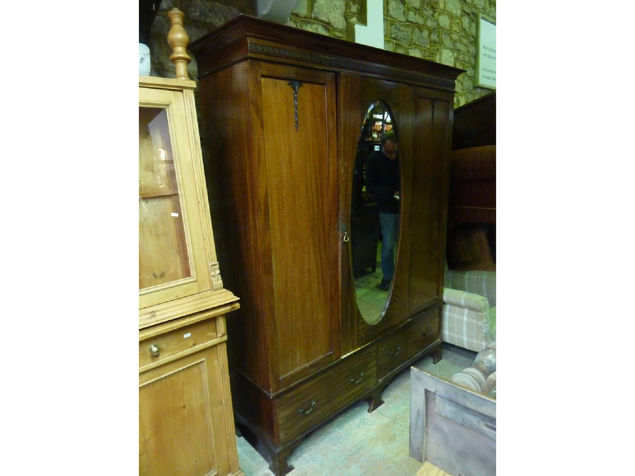 Appraisal: An Edwardian mahogany wardrobe the moulded cornice with Greek key