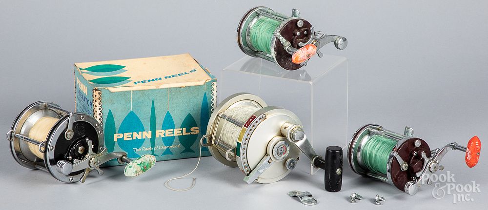 Appraisal: Three Penn fishing reels and another Three Penn fishing reels