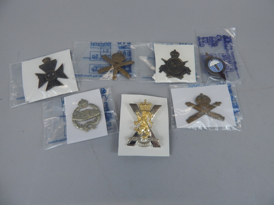 Appraisal: A quantity of military cap badges to include The Kings