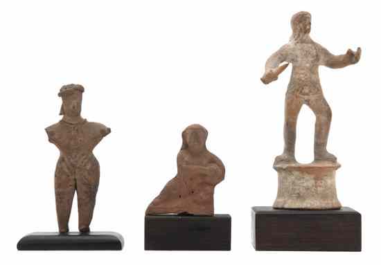 Appraisal: Three Terracotta Figures one of a gladiator holding a dagger