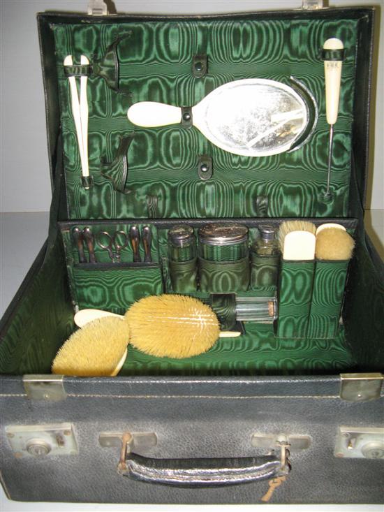 Appraisal: Leather dressing case the fitted interior with silver topped bottles