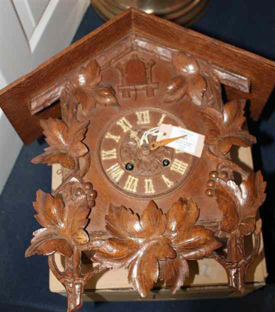 Appraisal: A Black Forest carved wood cuckoo clock with vine carved