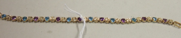 Appraisal: A gold amethyst and blue topaz set line bracelet claw