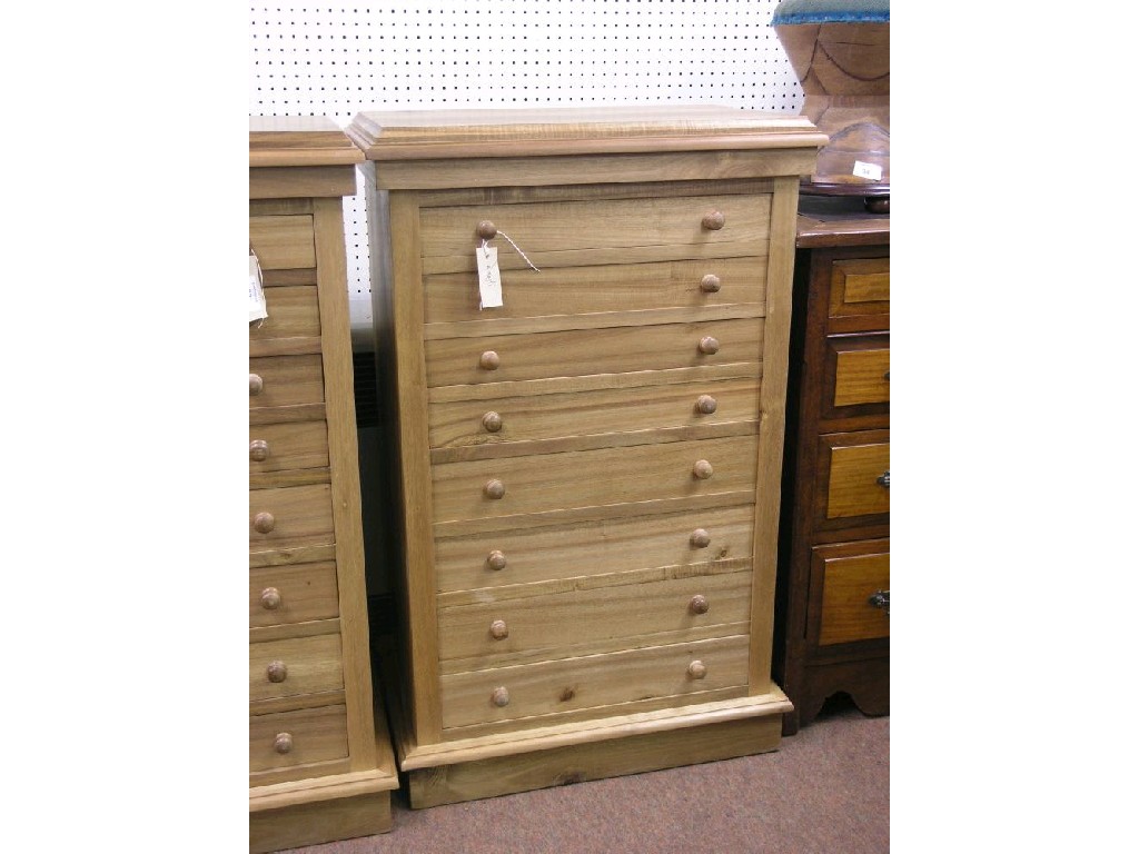 Appraisal: A reproduction pale mahogany Wellington chest eight drawers each with