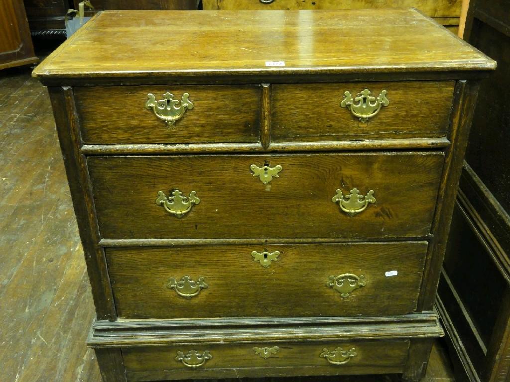 Appraisal: A small Georgian oak chest fitted with two long and