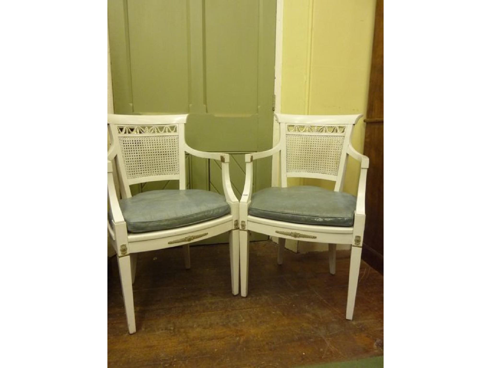 Appraisal: A pair of Regency style open elbow chairs with painted