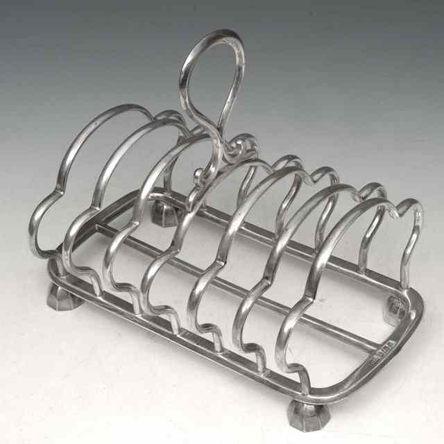 Appraisal: AN EDWARDIAN SILVER SIX DIVISIONAL TOAST RACK with shaped wirework