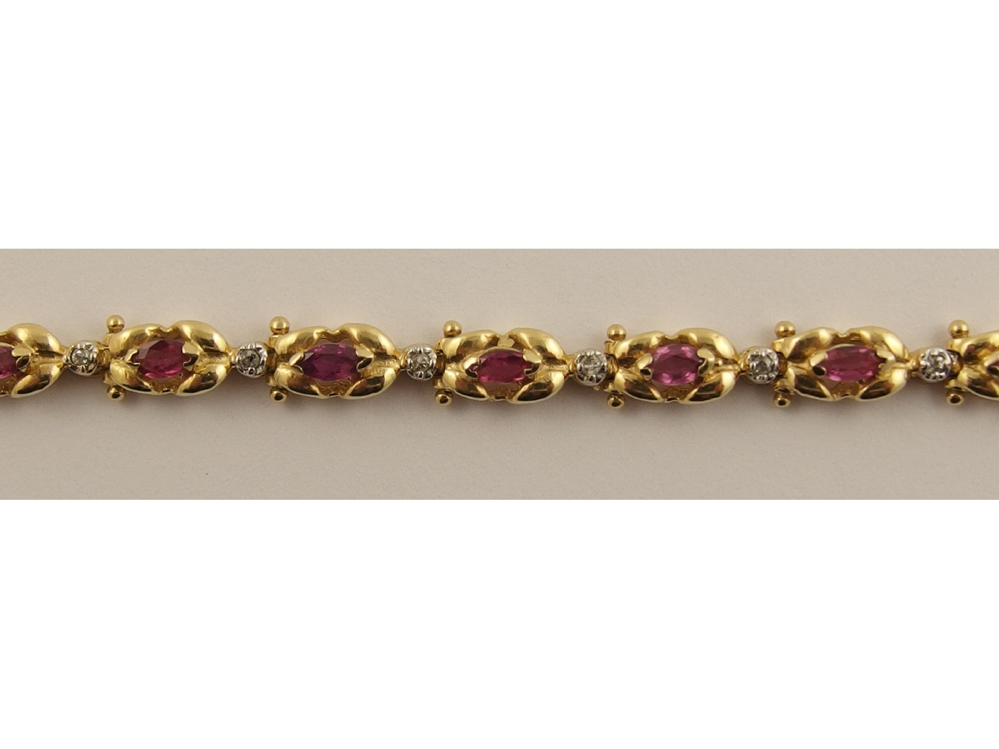 Appraisal: A ct diamond and red gem braceletthe twin leaf shaped