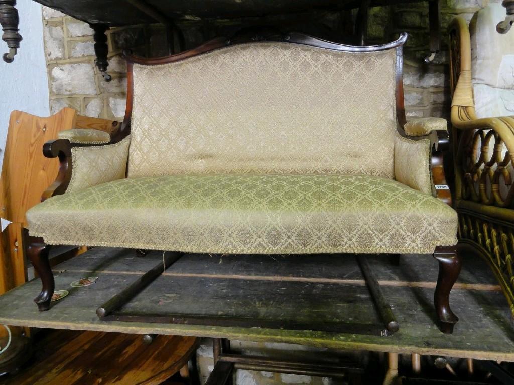 Appraisal: An Edwardian mahogany framed two seat sofa with shaped back