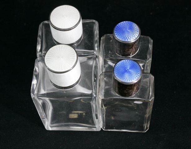 Appraisal: Four glass scent bottles with radiating and sunburst gilloche and