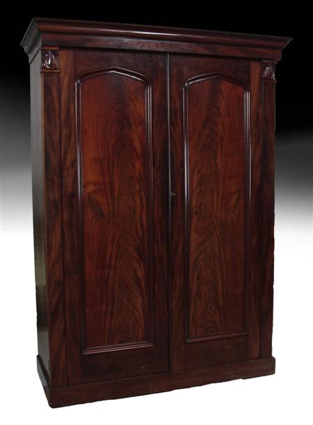 Appraisal: A Victorian flame mahogany wardrobe the projected moulded cornice over