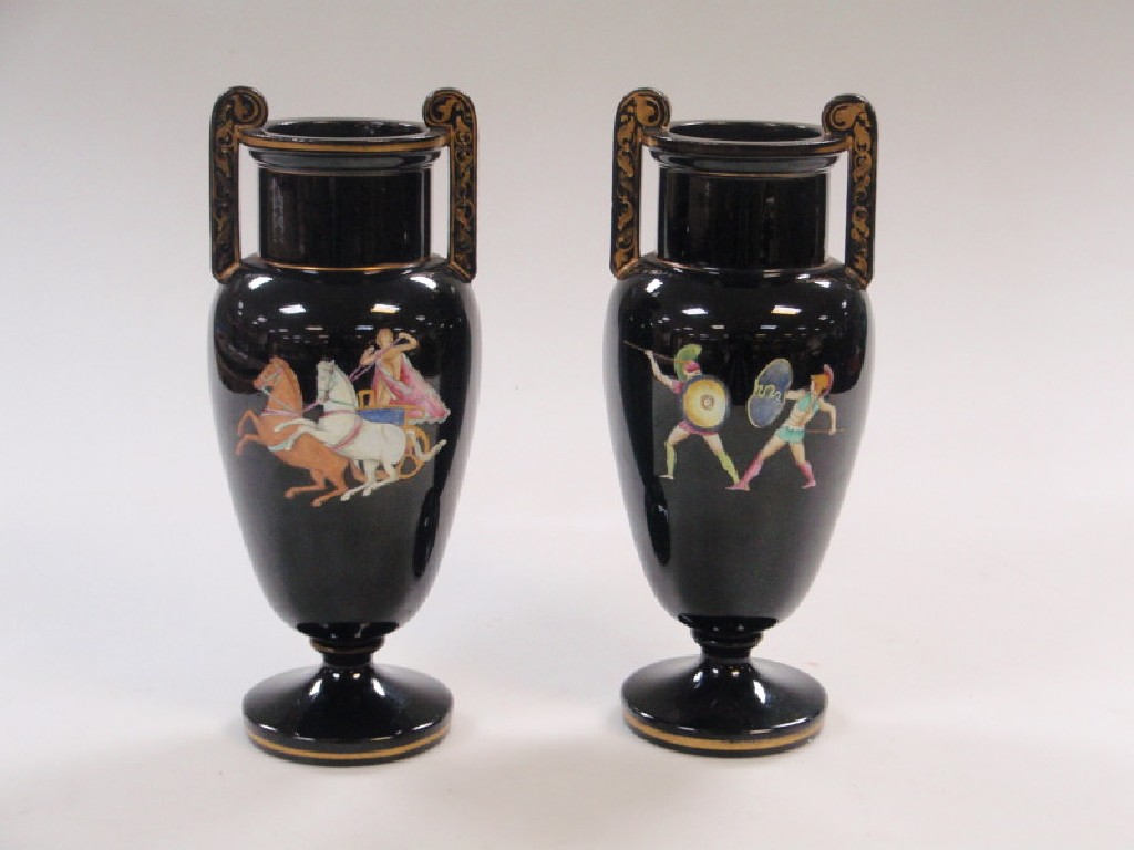 Appraisal: A pair of black ground two-handled ovoid vases and decorated