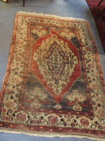 Appraisal: A TURKISH RUG decorated a central medallion on a pastel