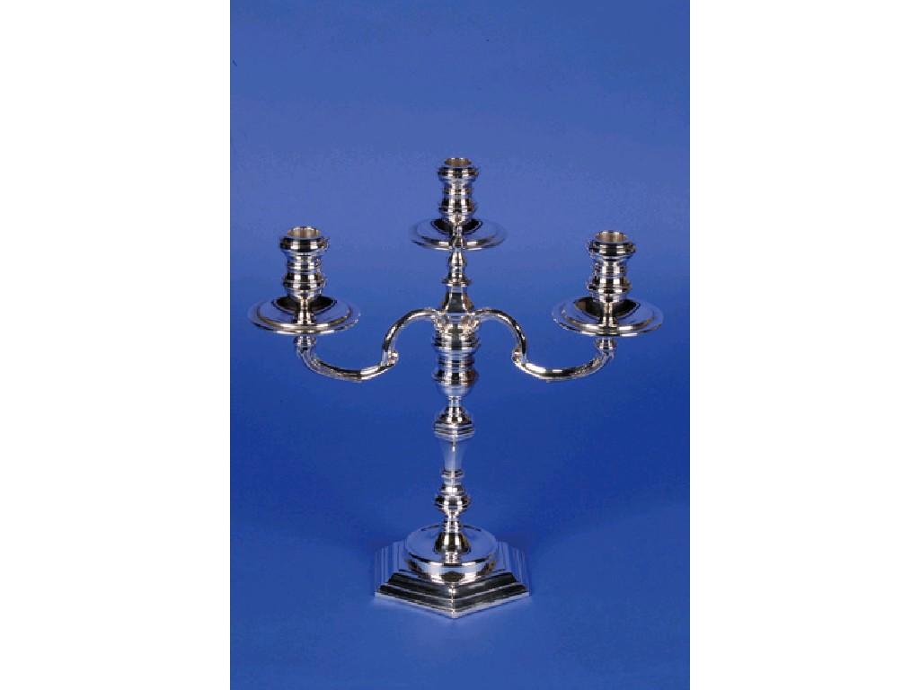 Appraisal: A THREE BRANCH CANDELABRUM with turned circular sconces and shallow