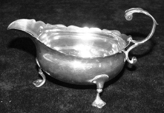 Appraisal: A George II sauce boat with shaped border and C