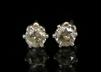 Appraisal: A Pair of Diamond Studs Sterling silver settings feature carat