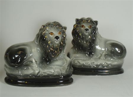 Appraisal: A pair of th century Bo'ness type lions lying on