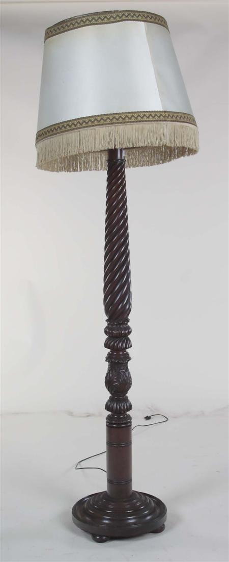 Appraisal: A th carved mahogany standard lamp the spirally carved column