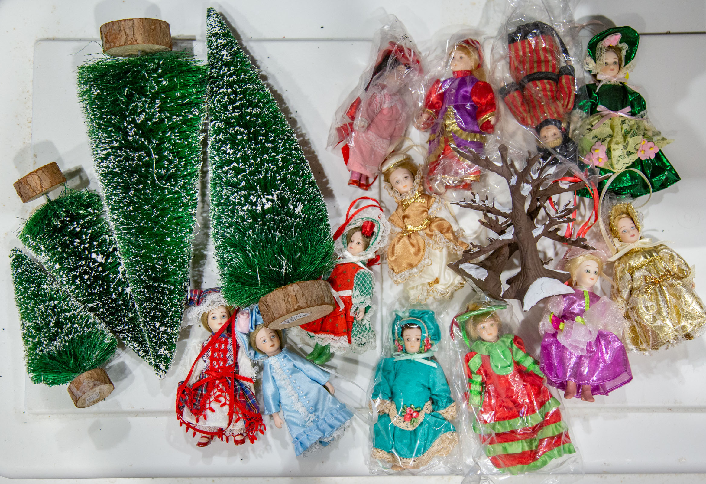 Appraisal: MINIATURE DOLLS MINIATURE DECORATIVE TREES Dolls in ethnic dress trees