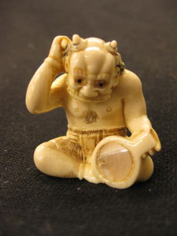 Appraisal: Carved Ivory Netsuke of a Seated Oni mischief-maker with onyx