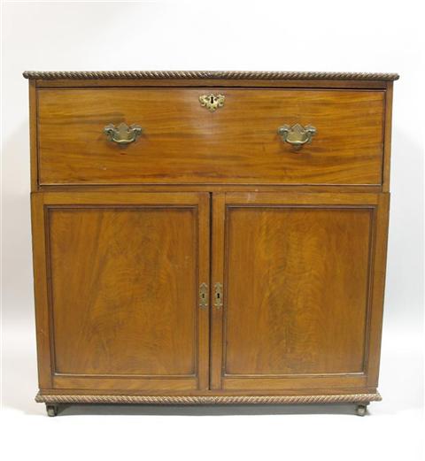 Appraisal: ENGLISH REGENCY STYLE MAHOGANY BUTLER'S DESK The rectangular top with