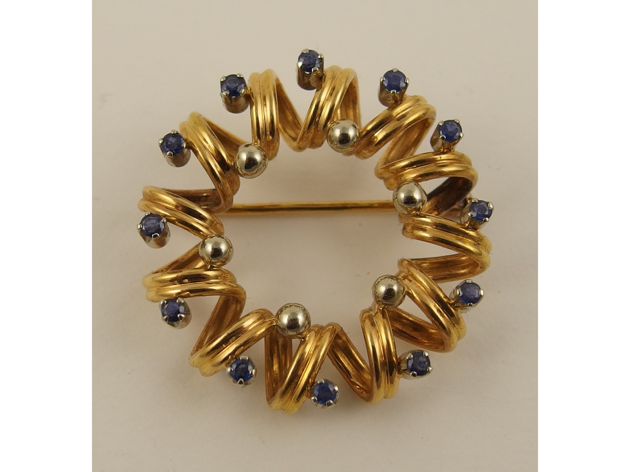 Appraisal: An ct round brooch formed from a spiral and set