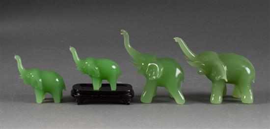 Appraisal: Four Peking emerald glass elephant figures each modeled as trumpeting