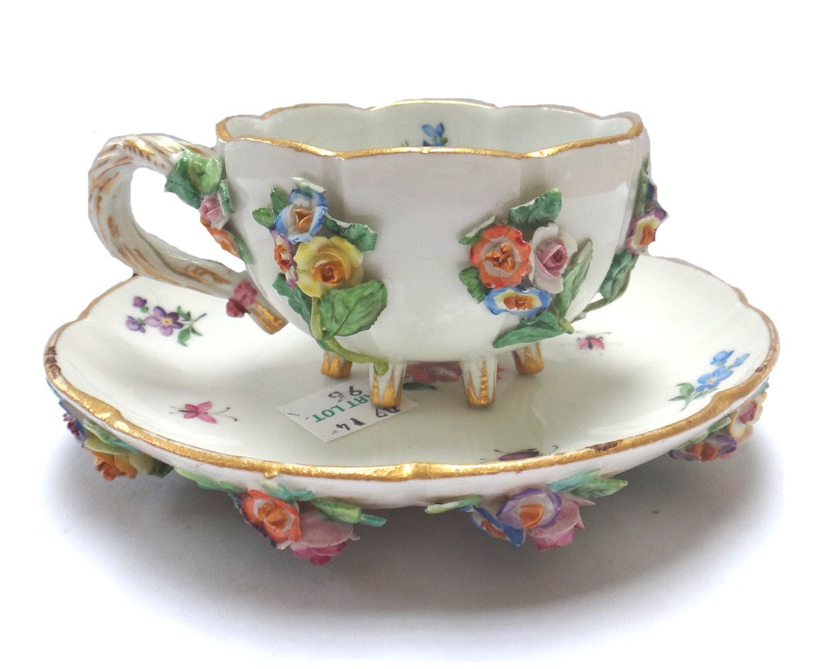 Appraisal: A Meissen flower encrusted cup and saucer late th century