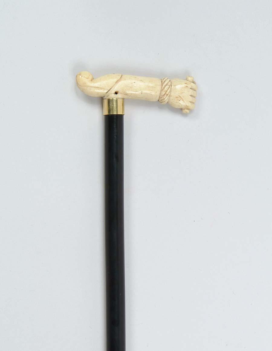 Appraisal: CANE CARVED IVORY ARM WITH FIST Handle has carved fist