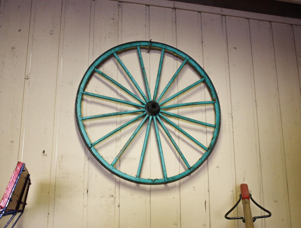 Appraisal: A PAIR OF WAGON WHEELS turquoise painted wood with iron