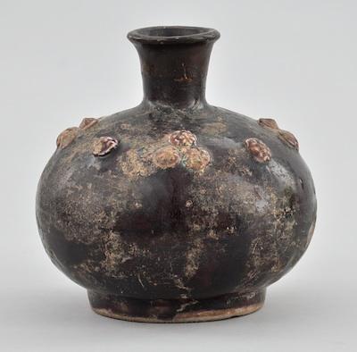 Appraisal: Persian Pottery with Aubergine Glaze Possibly Raqqa pottery earthenware bulbous