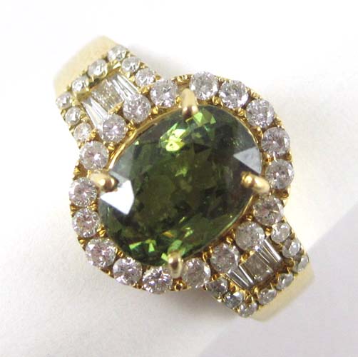 Appraisal: DEMANTOID DIAMOND AND FOURTEEN KARAT GOLD RING with round-cut and