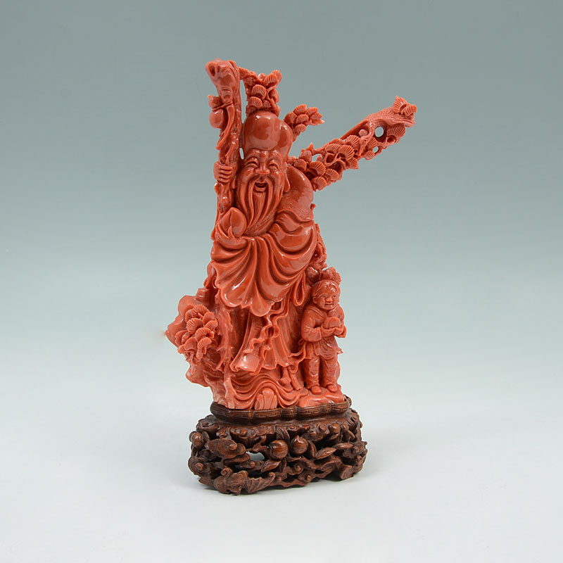 Appraisal: CARVED CORAL FIGURE OF FUKUROKUJU ATTENDANT Carved coral figural group