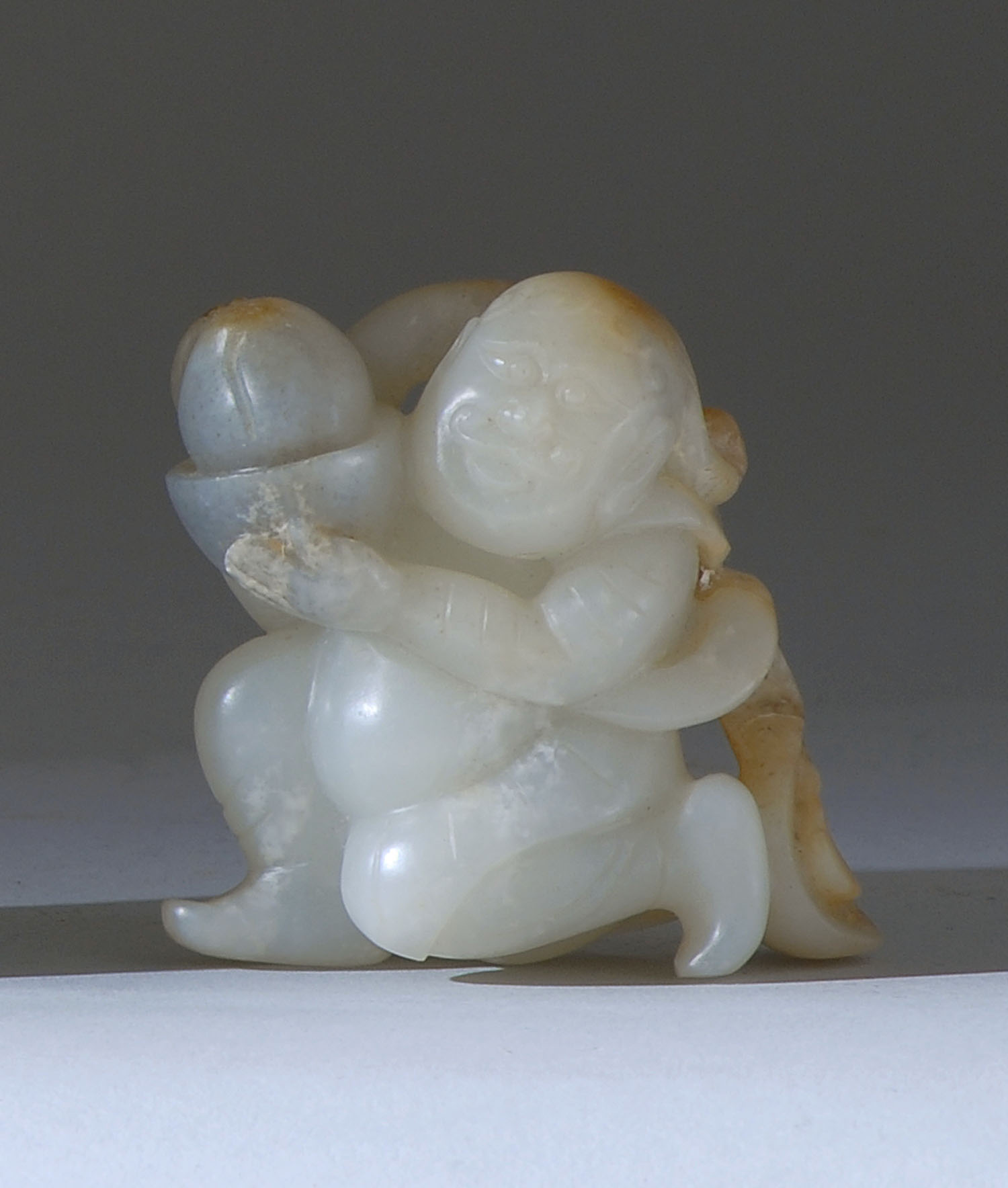 Appraisal: WHITE AND GRAY JADE CARVING In the form of a