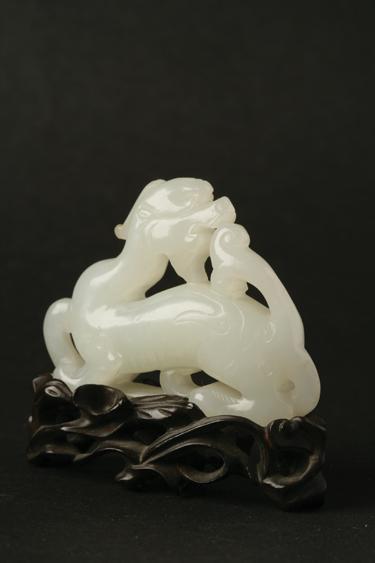 Appraisal: A CHINESE WHITE JADE CARVING of a mythical beast probably