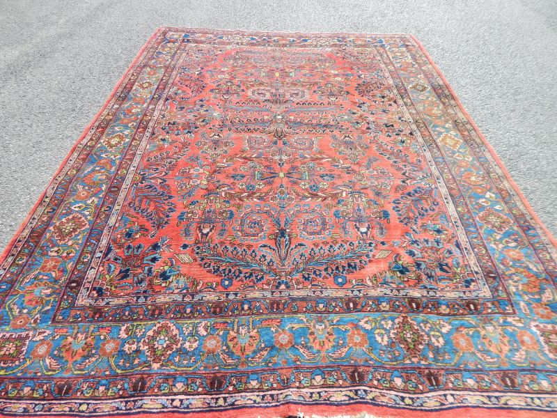 Appraisal: A Persian carpet with a design of leaves and flowers