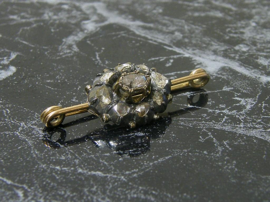 Appraisal: Antique rough cut diamond brooch set with nine diamonds in