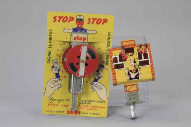 Appraisal: TWO HAND SQUEEZE SPARKLER TOYS Includes French Policemen ''STOP'' examples