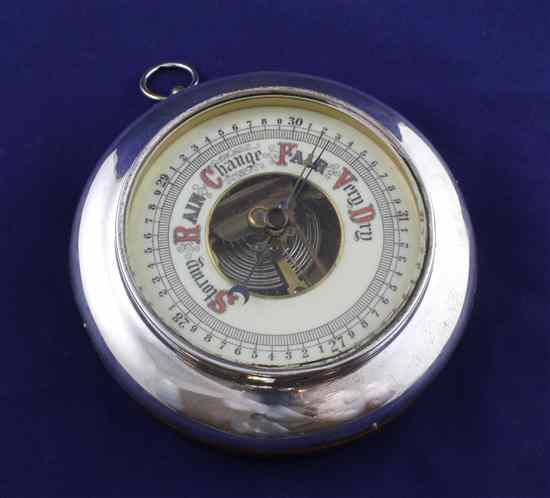 Appraisal: An Edwardian silver mounted walnut aneroid barometer of circular form