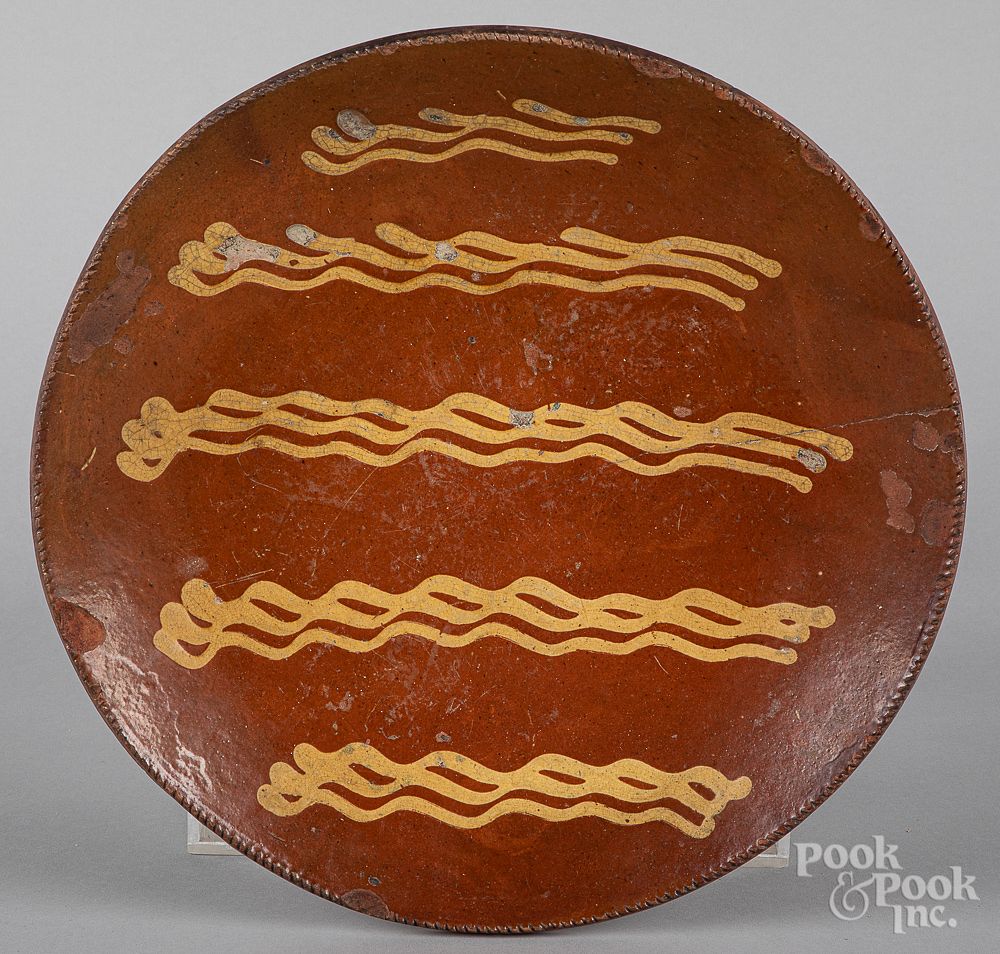 Appraisal: Pennsylvania redware charger Pennsylvania redware charger th c with yellow