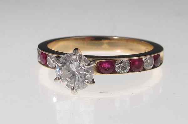 Appraisal: DIAMOND SOLITAIRE AND RUBY ENGAGEMENT RING k yellow gold ring