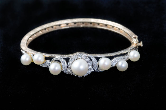 Appraisal: EDWARDI AN DIAMOND AND PEARL HINGED BANGLE BRACELET Set with