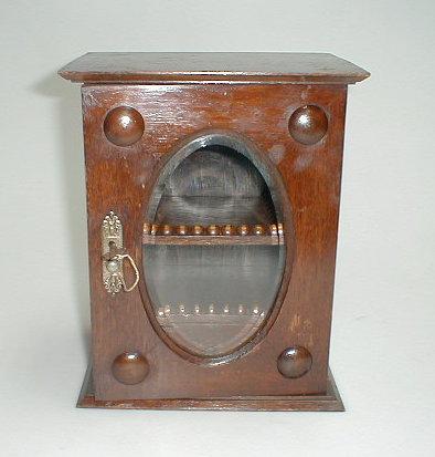 Appraisal: An early thC oak smoker's cabinet with a single glazed