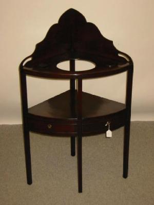 Appraisal: A MAHOGANY WASHSTAND c and later of quadrant form with