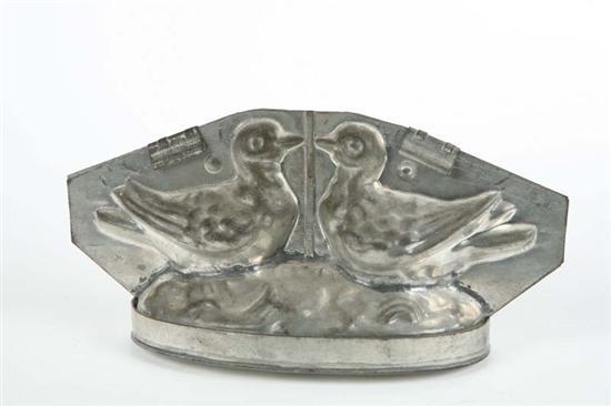 Appraisal: CHOCOLATE MOLD Tin kissing doves standing on an oval base