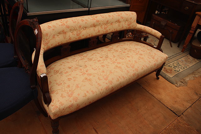 Appraisal: A VICTORIAN MAHOGANY SMALL SOFA the button upholstered shaped back