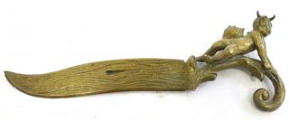 Appraisal: Figural Bronze Letter Opener The incised curved blade with scroll-form