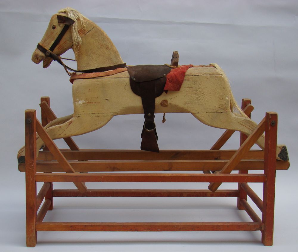 Appraisal: ANTIQUE AMERICAN ROCKING HORSE th CenturyIn white paint Red-stained carriage